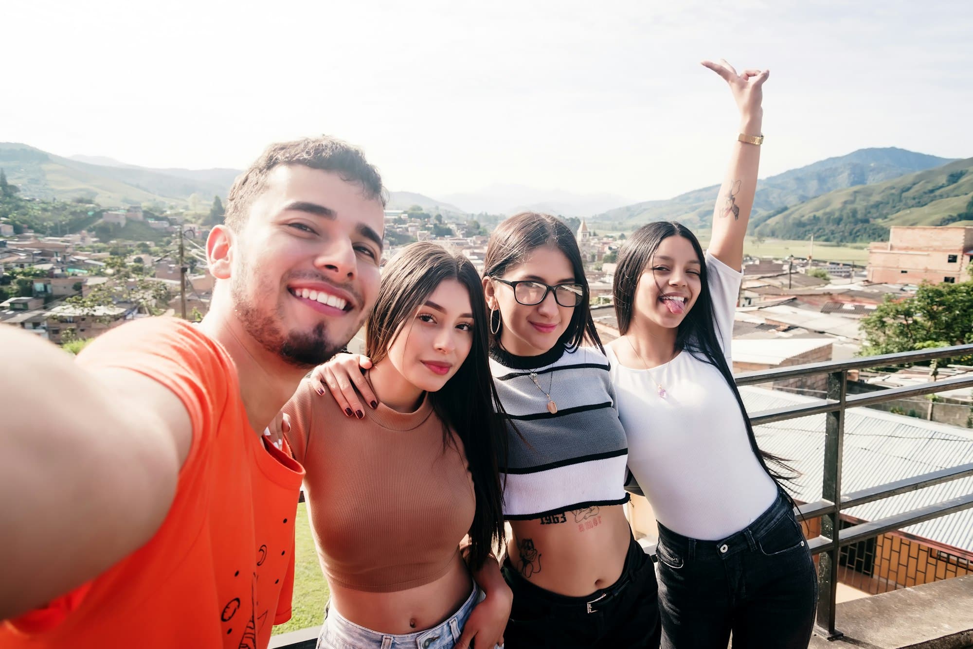 Group of friends taking a selfie from a lookout point in a Colombian village