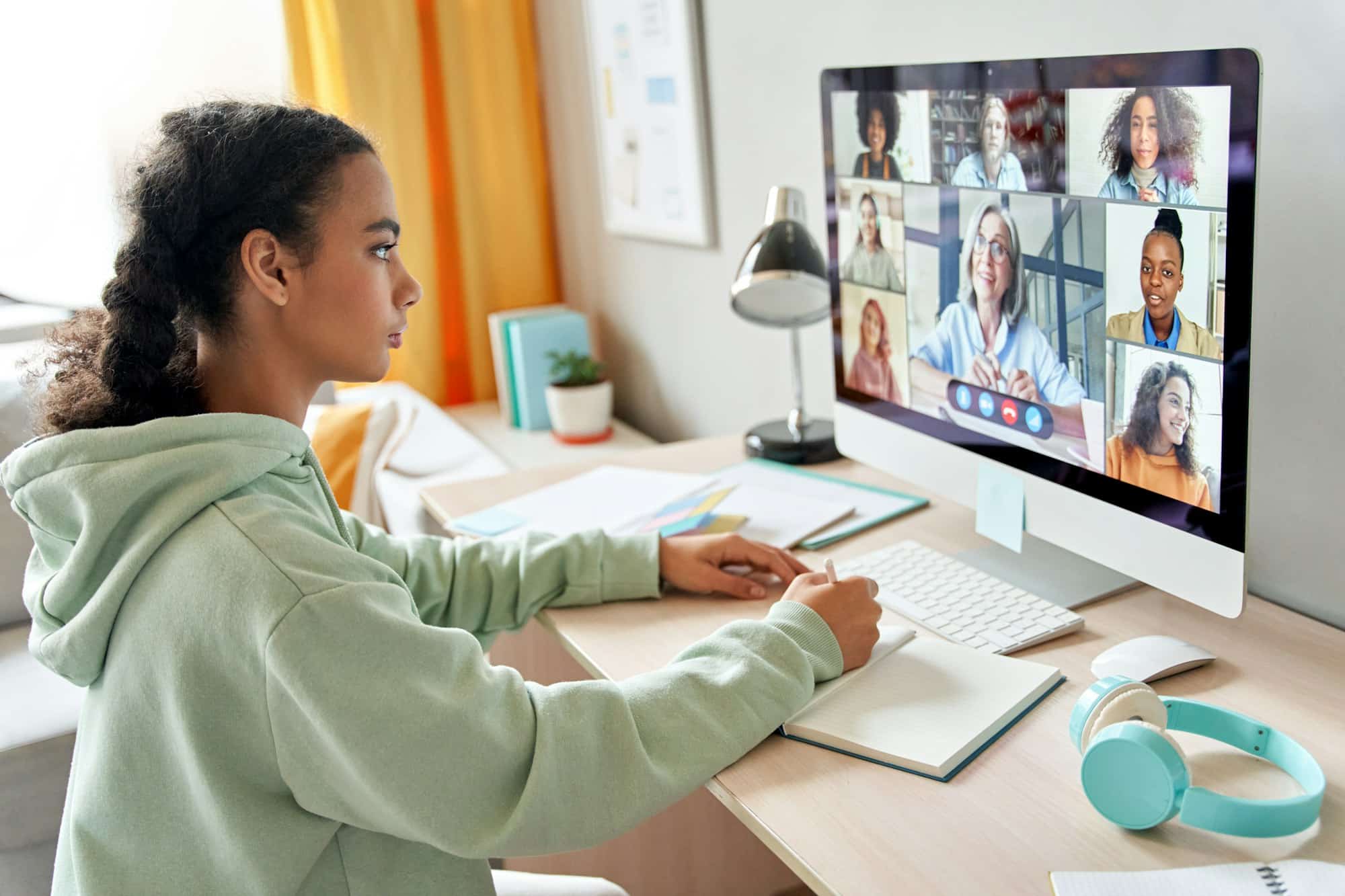 Mixed race teen school girl remote learning during online group class.